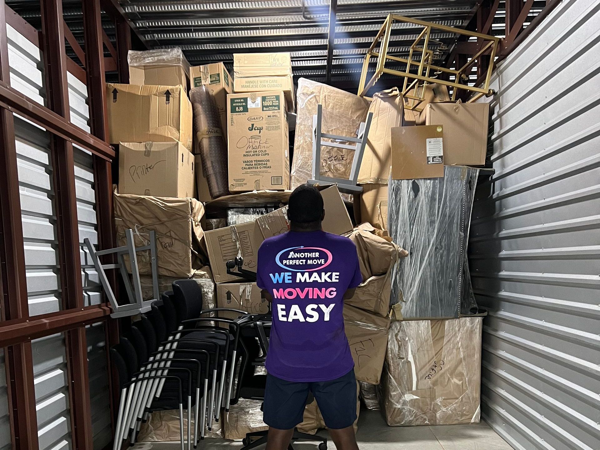 Two delivery men are loading boxes into a van.