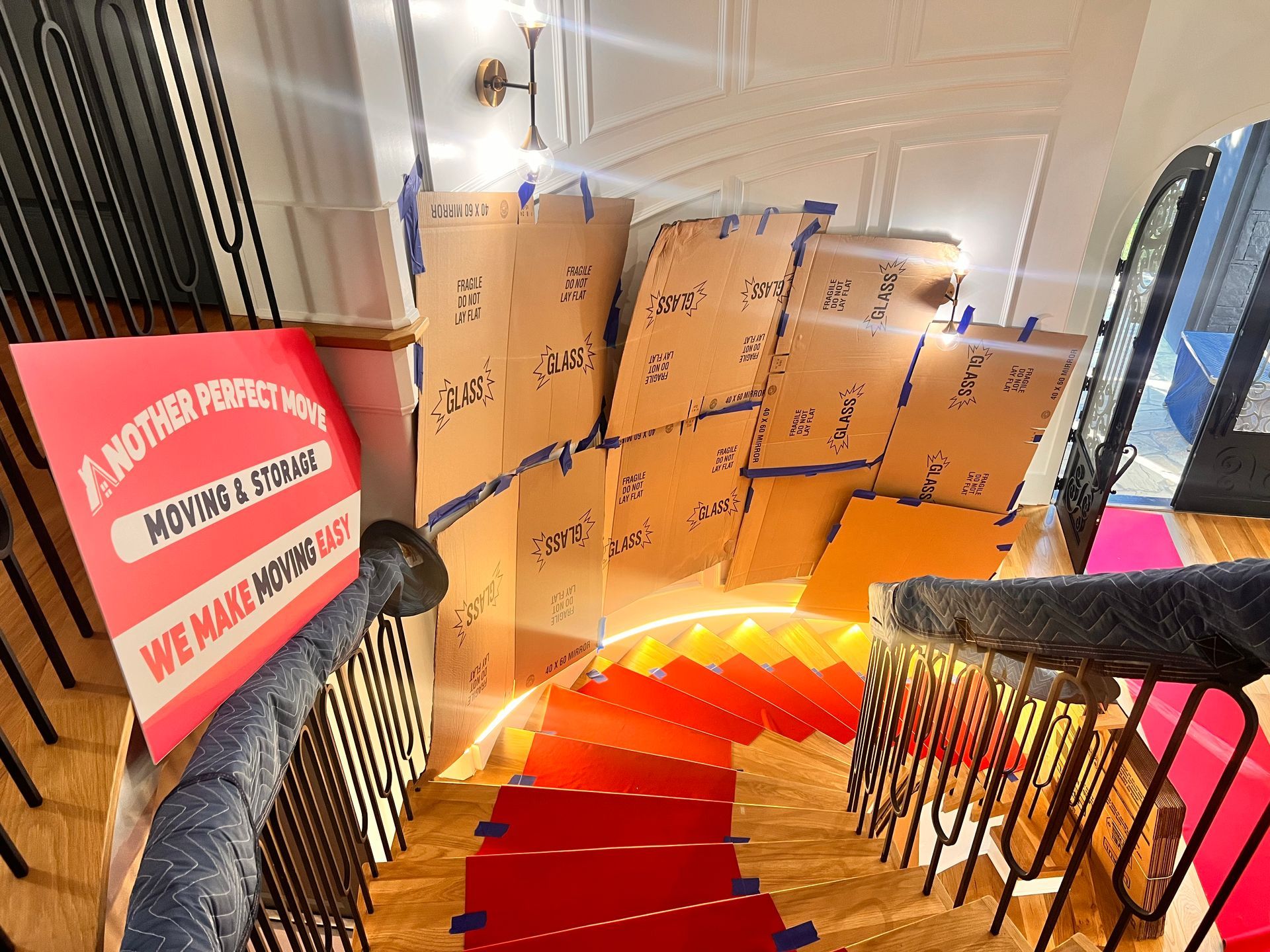 A staircase filled with boxes and a sign that says we make moving easy