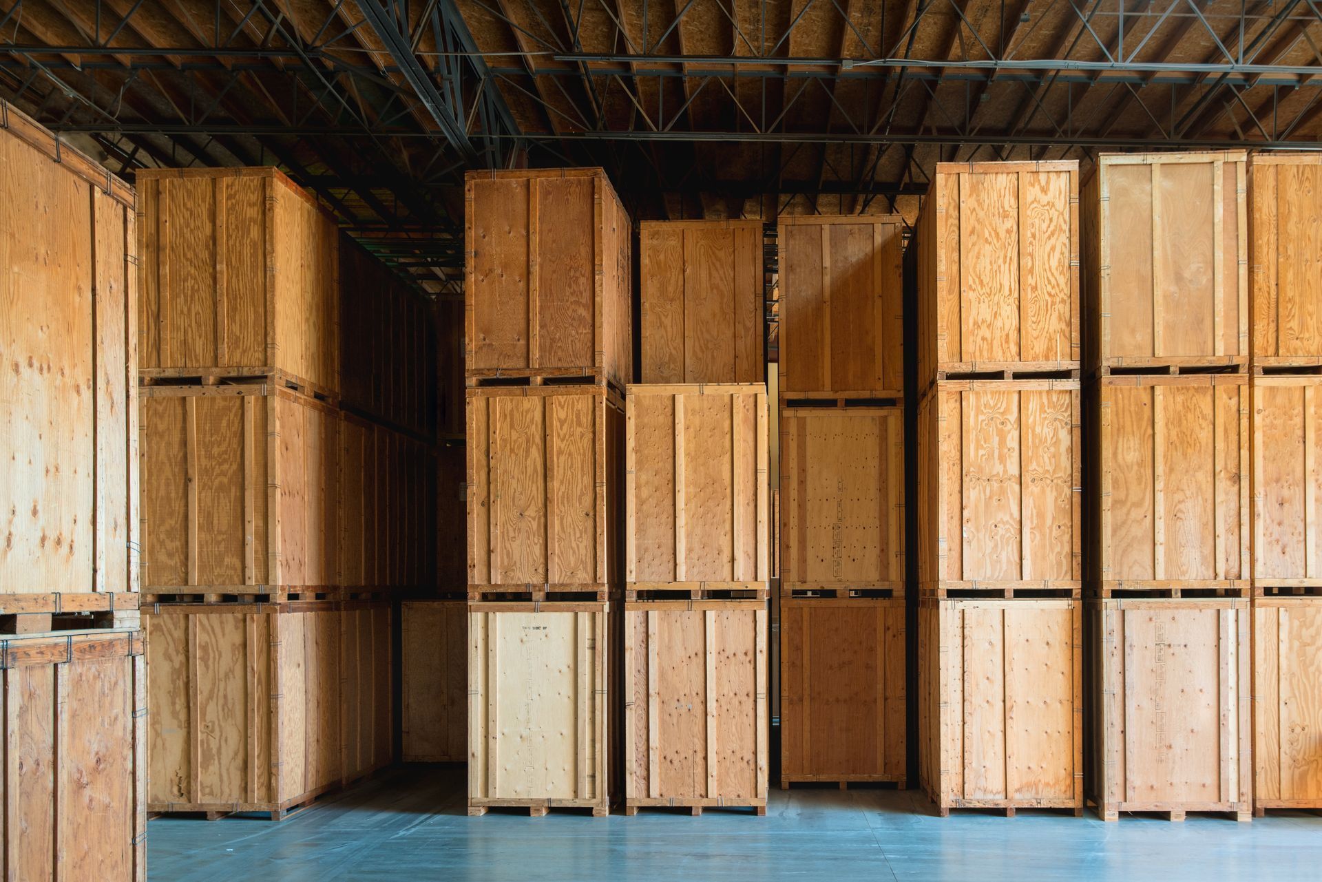 A warehouse filled with lots of wooden crates stacked on top of each other.