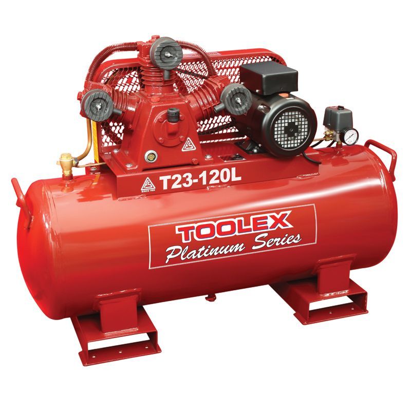 A bunch of air compressors are stacked on top of each other in a room.