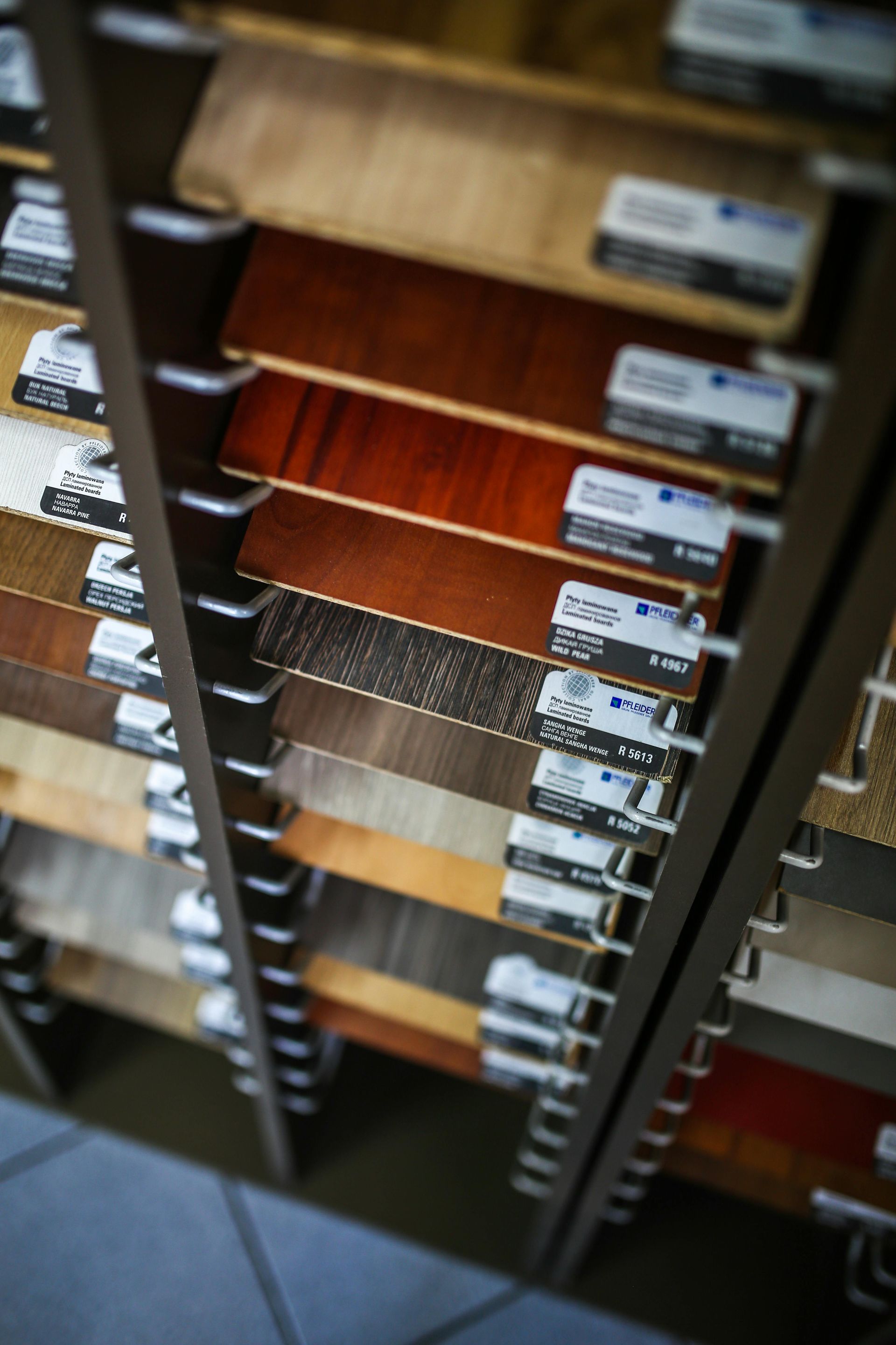 Shelves displaying various wood flooring samples in different colors and finishes.