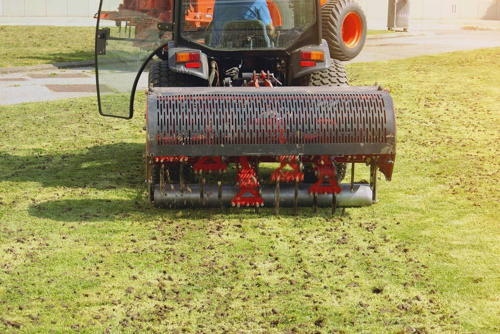Operating Soil Aeration Machine On Grass Lawn
