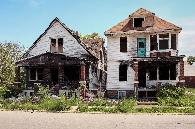 A newly constructed house in progress with an unfinished exterior, black roofing, and open window spaces. Hawaii Home Buyers LLC helps homeowners sell fast.