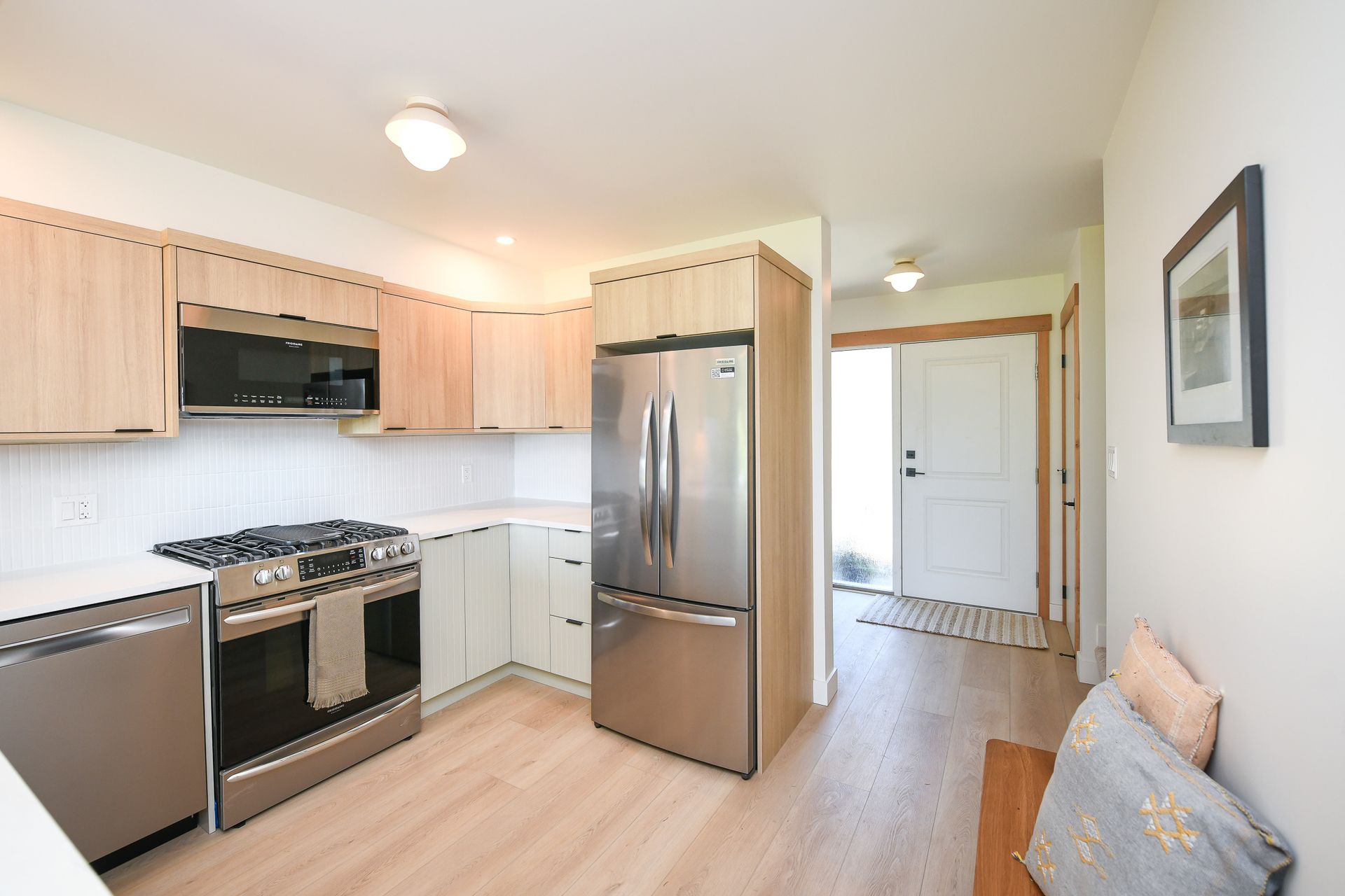 A kitchen with stainless steel appliances and wooden cabinets
