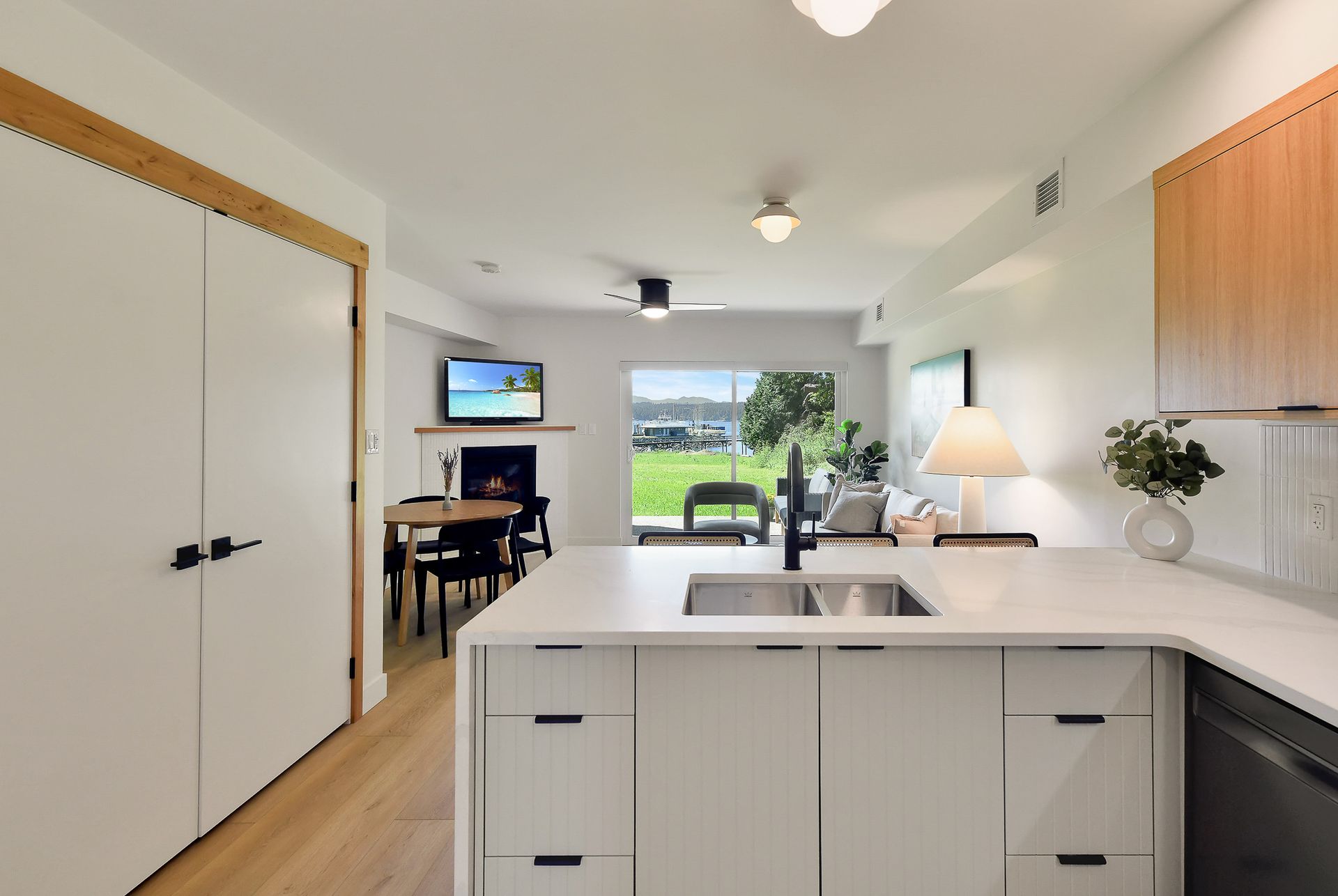 A kitchen with white cabinets and a sink in it