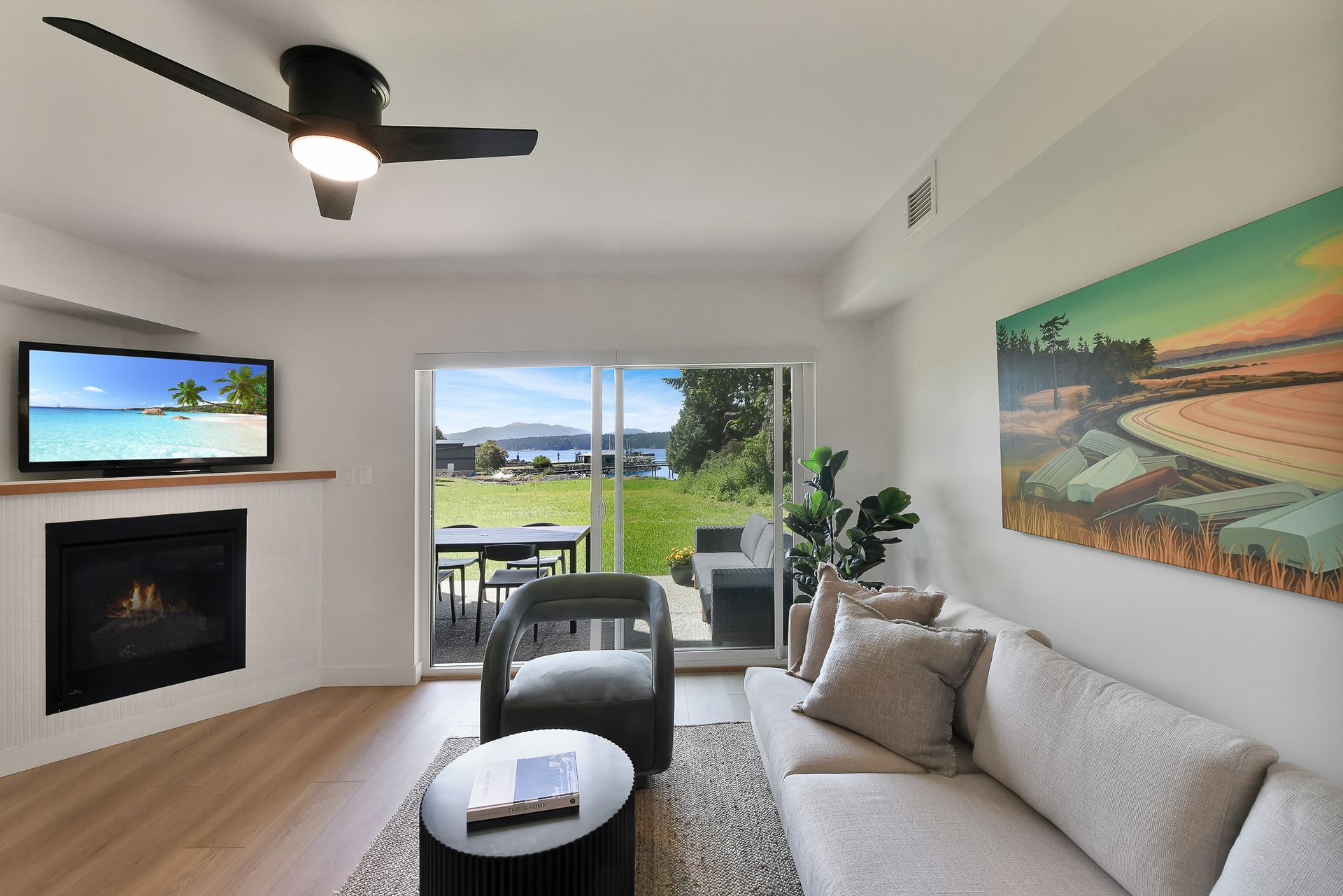 A living room with a couch fireplace and television