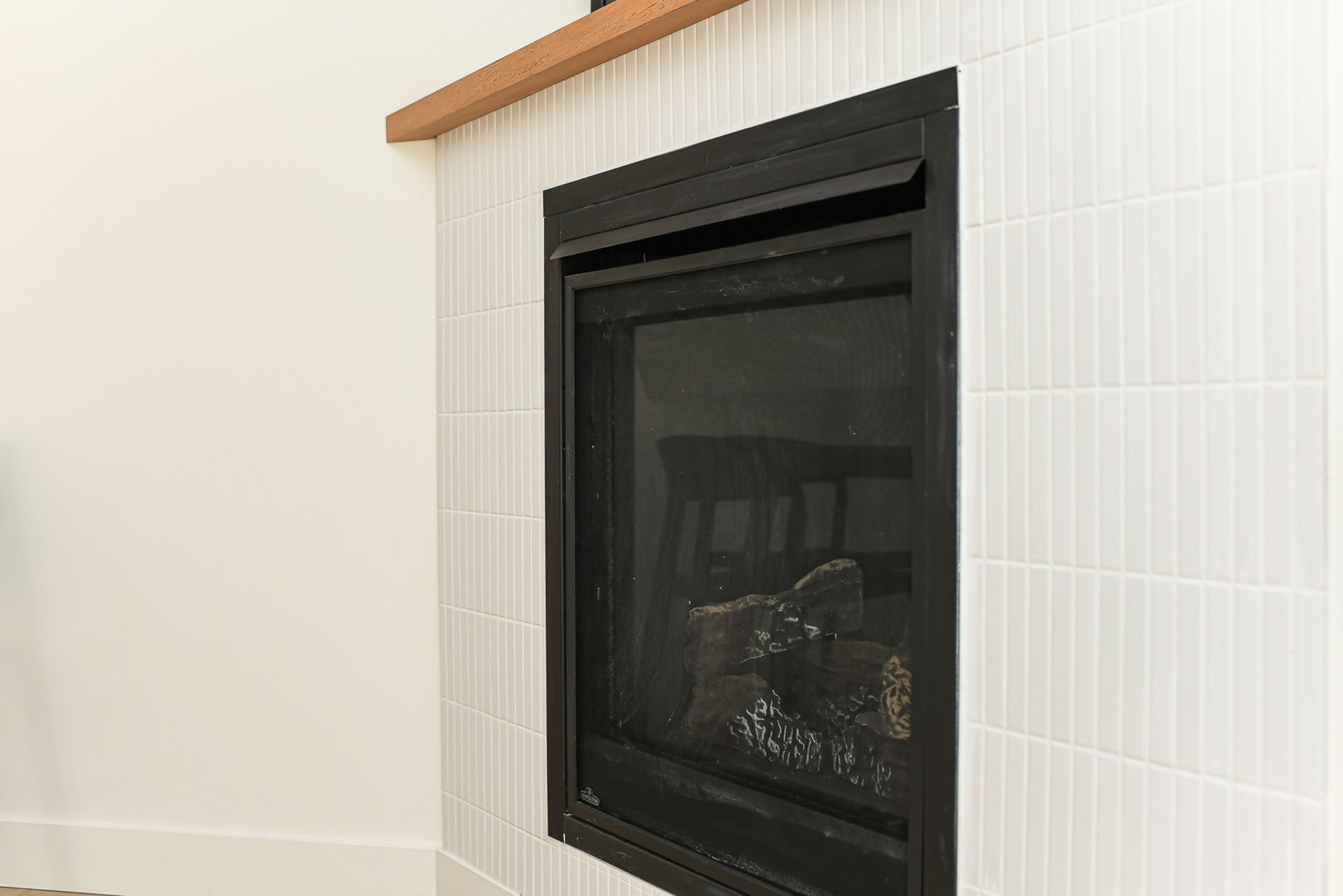 There is a fireplace in the corner of the room.