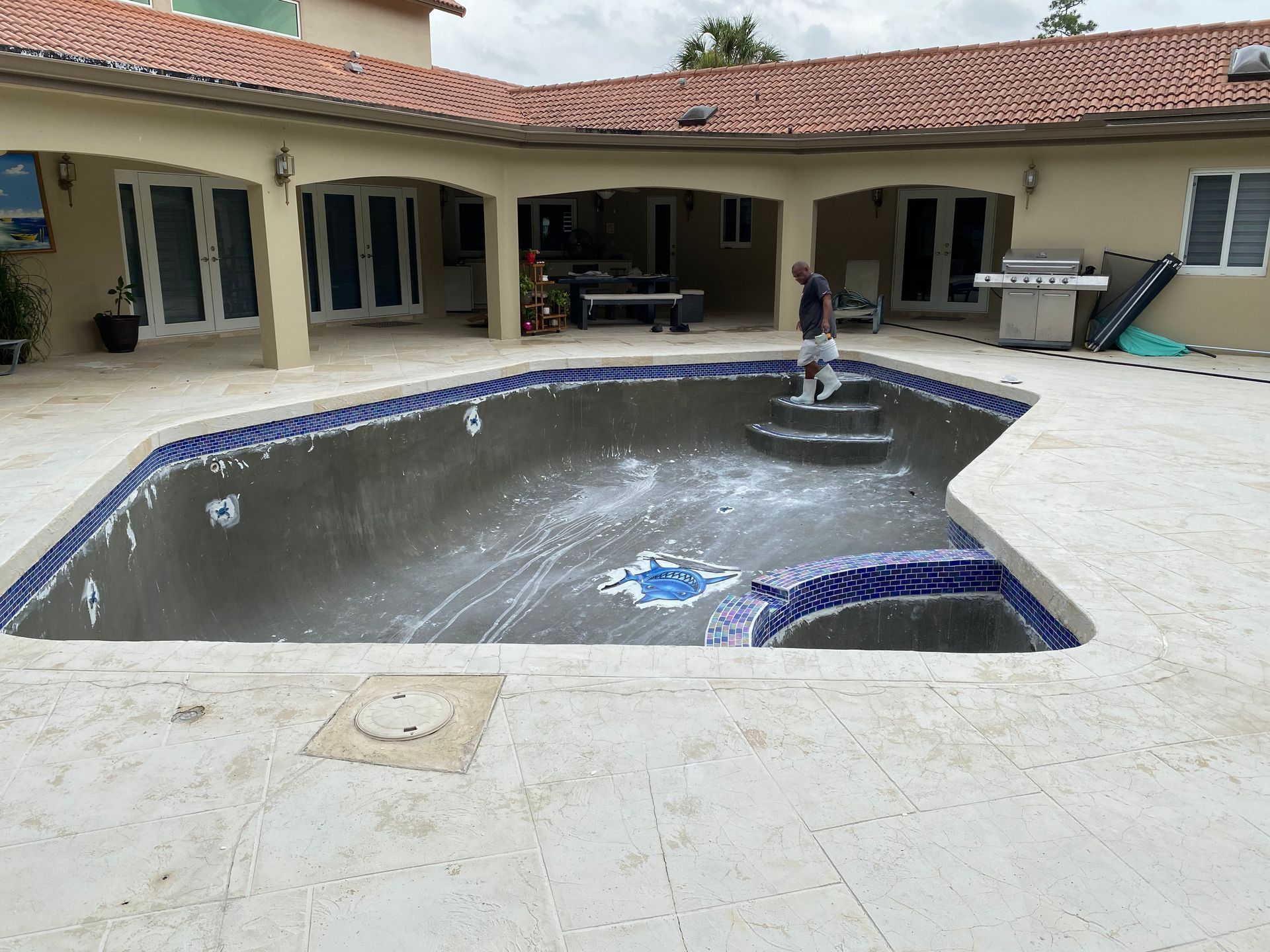 A large swimming pool in the backyard of a house