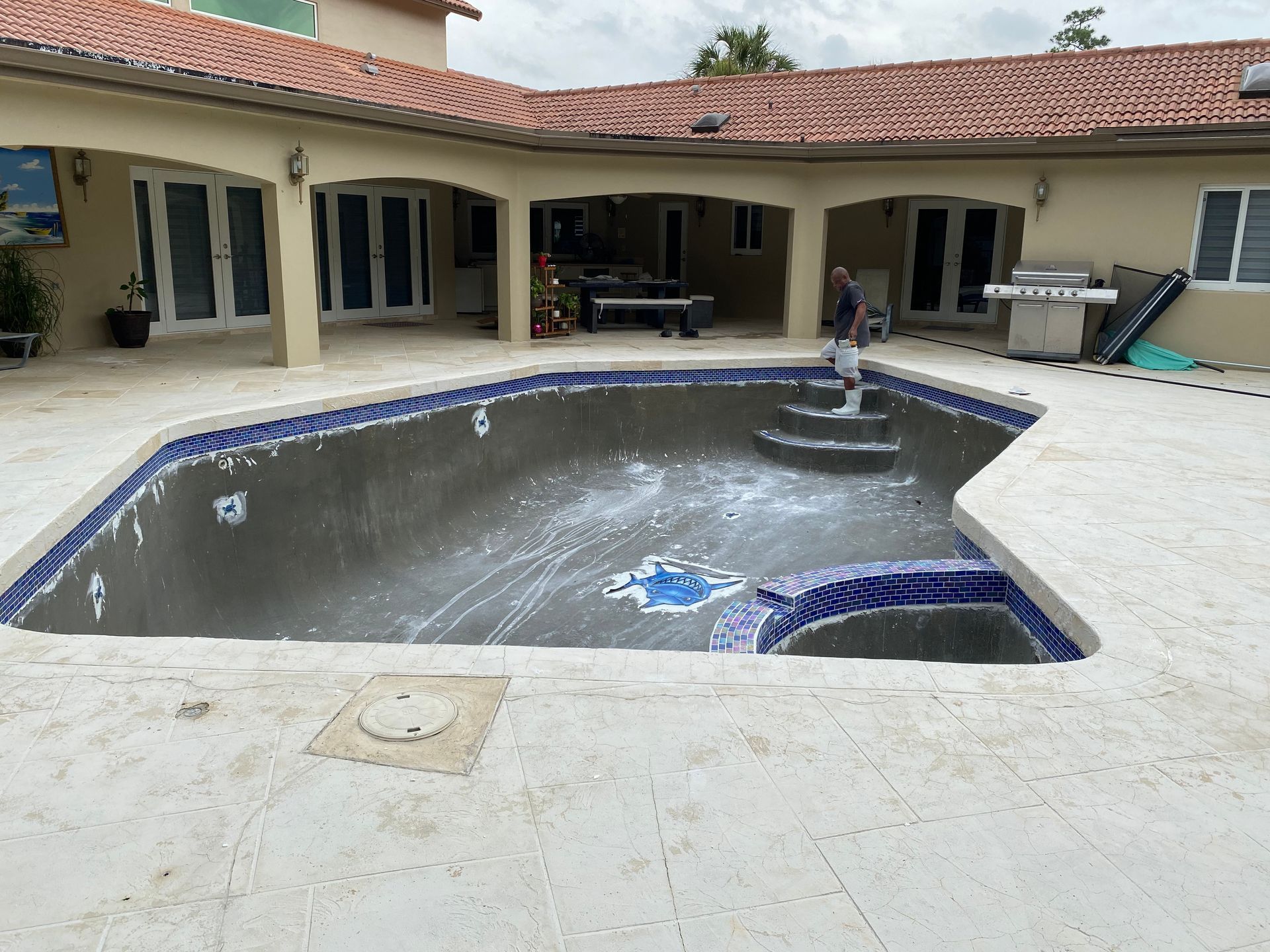 A large swimming pool in the backyard of a house