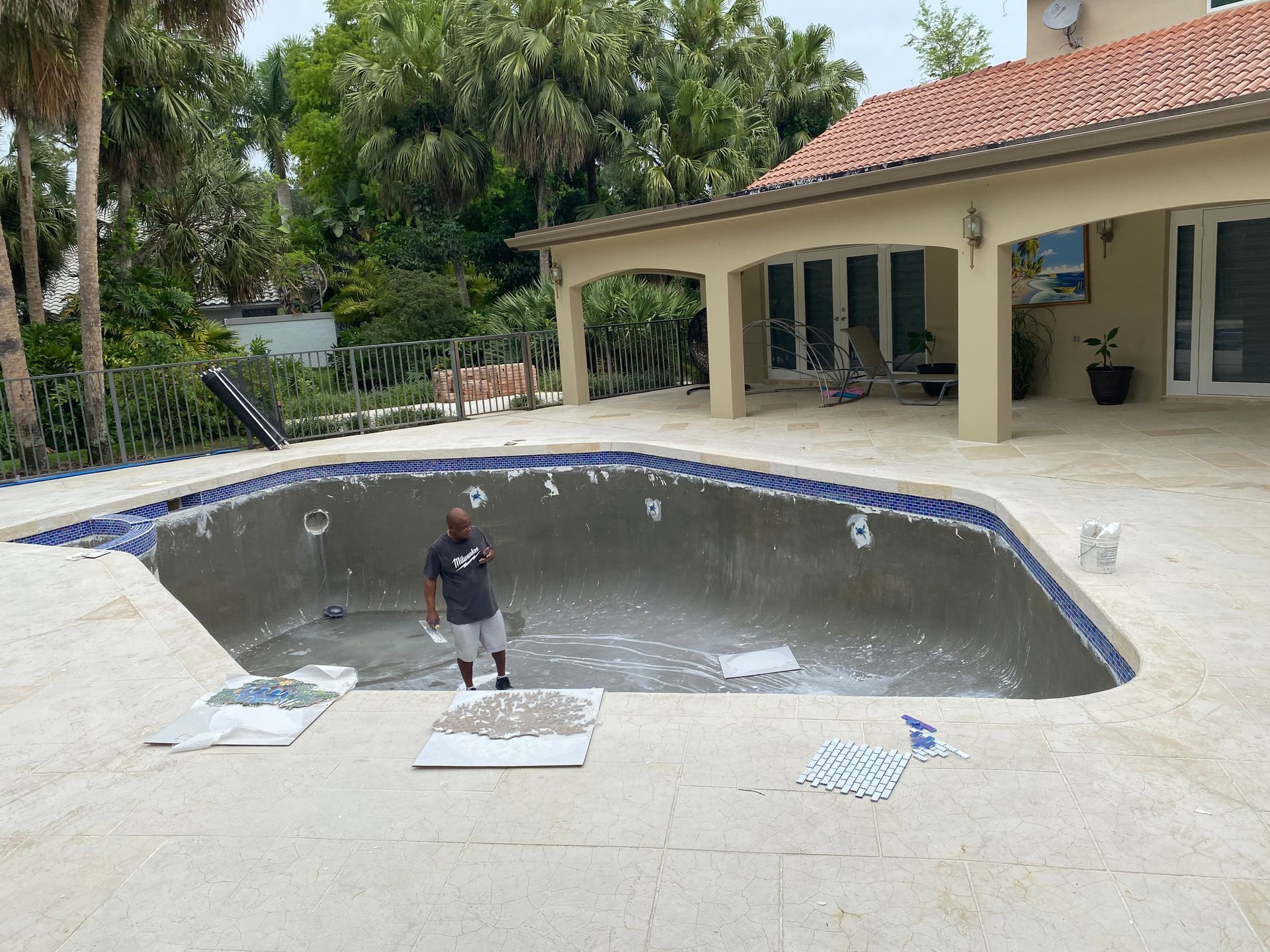 A man is standing in the middle of a swimming pool