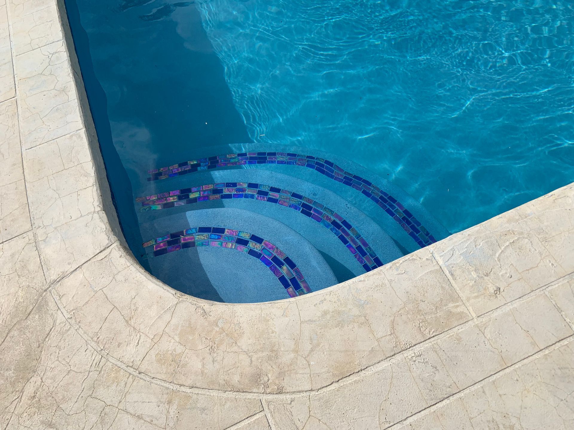 A close up of a swimming pool with stairs in it