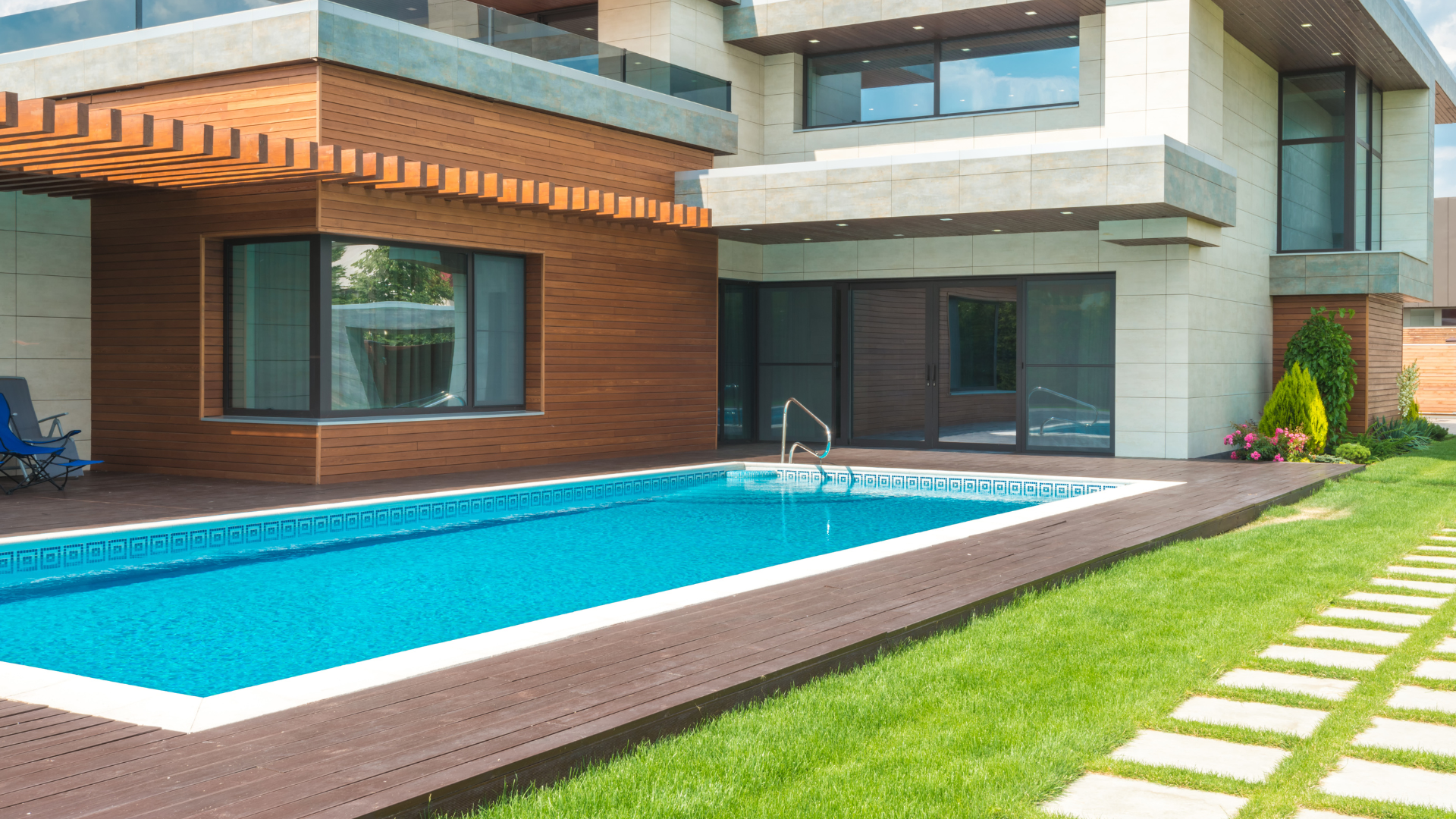 A large house with a swimming pool in front of it.