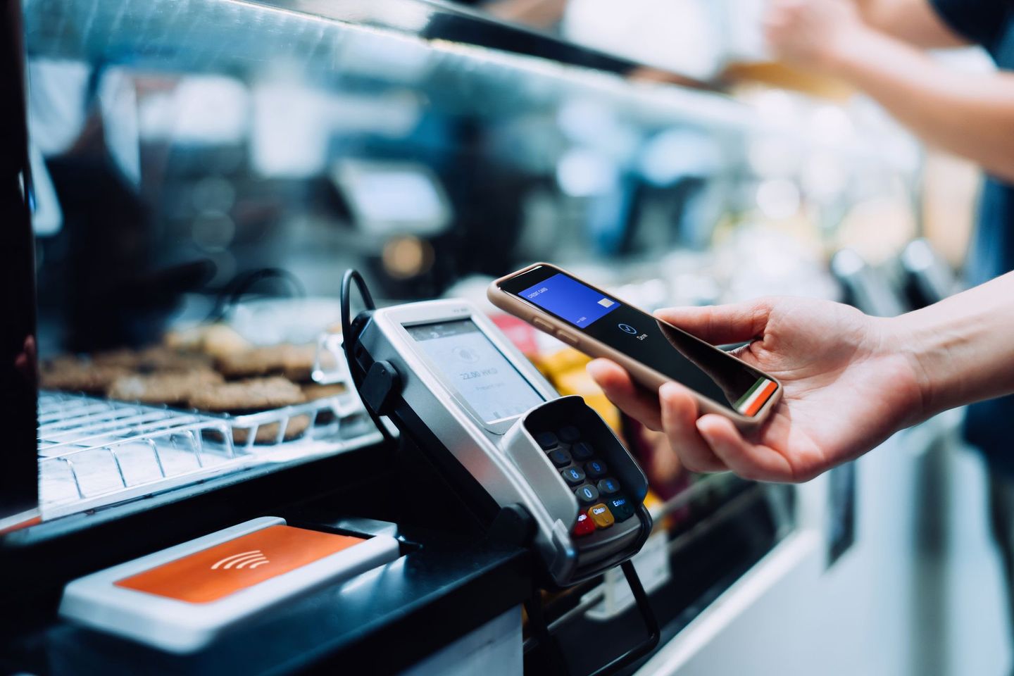 A Person is using a Smartphone to Pay for something in a Store — Overland Park, KS — Premier Payment Solutions