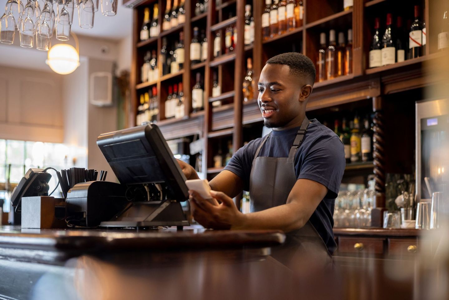 Waiter placing an Order in the System using a Computer — Overland Park, KS — Premier Payment Solutions
