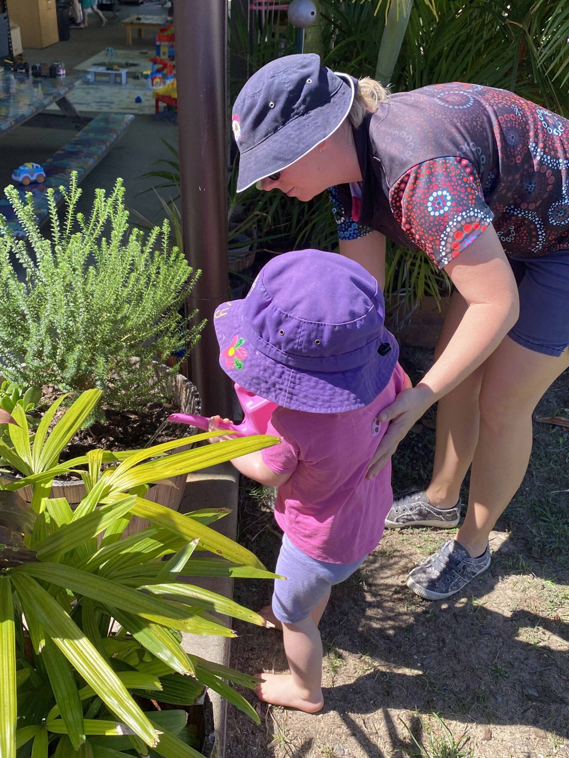 Little Girl Watering Plants — Emu Park, QLD — Coastal Kids