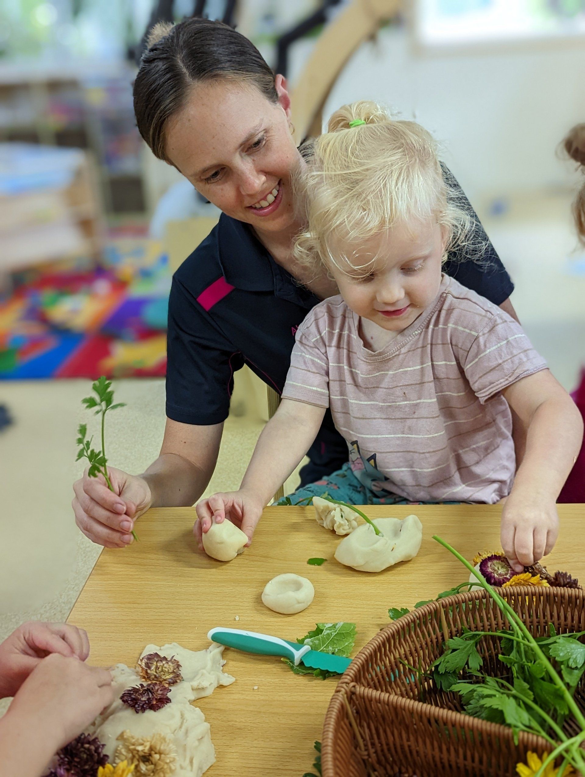 Teacher and Girl Playing Clay and Plants — Emu Park, QLD — Coastal Kids