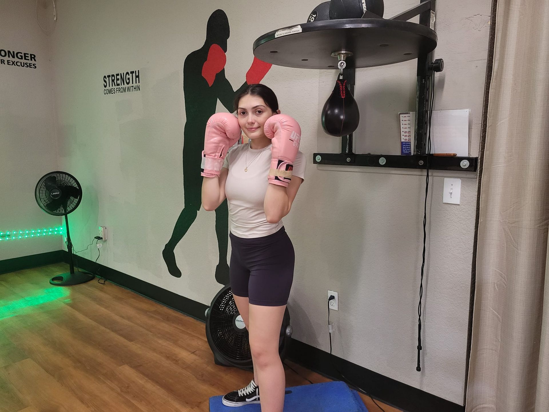 a women with boxing gloves on is posing