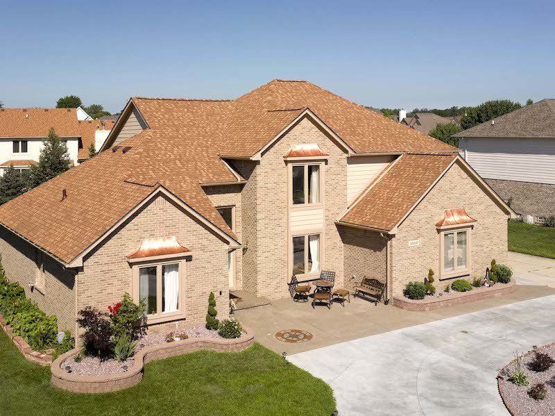 Resawn Shake Landmark Architectural Asphalt Shingle Residential Roof on a 2 story home with copper awnings