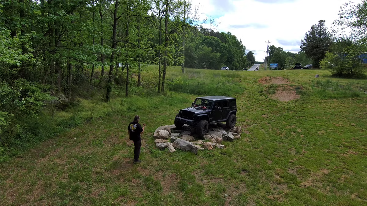 an aerial view of a guy and a jeep