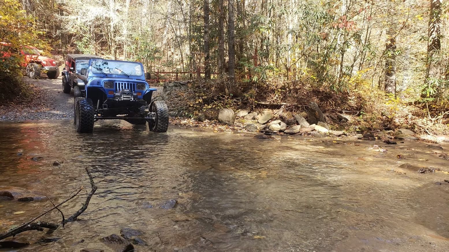 a off road truck crossing a river