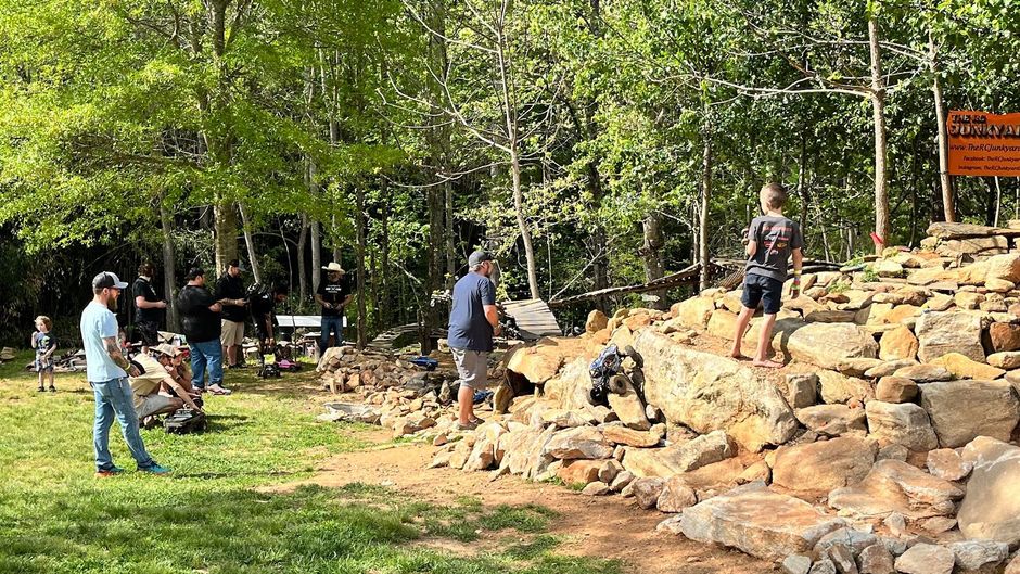 An aerial view of a garage with a bunch of jeep 's parked in front of it.
