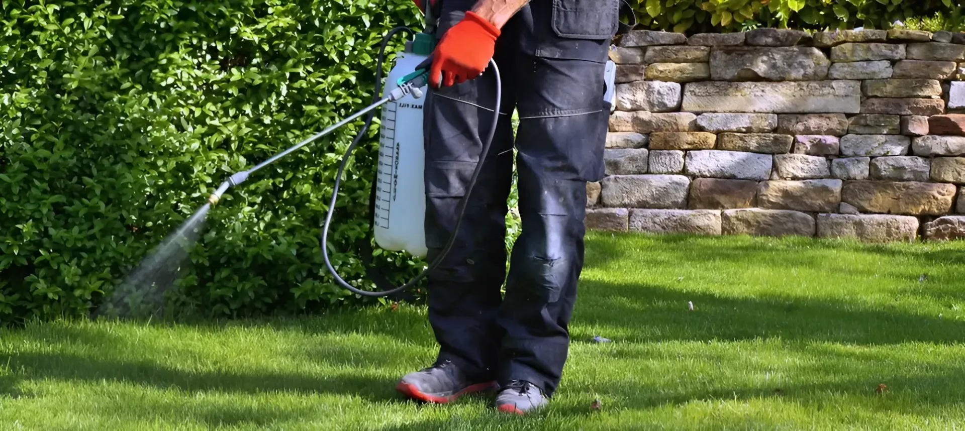 Person Spraying a Green Lawn With a Garden Sprayer — Garden City Slashing in Highfields, QLD