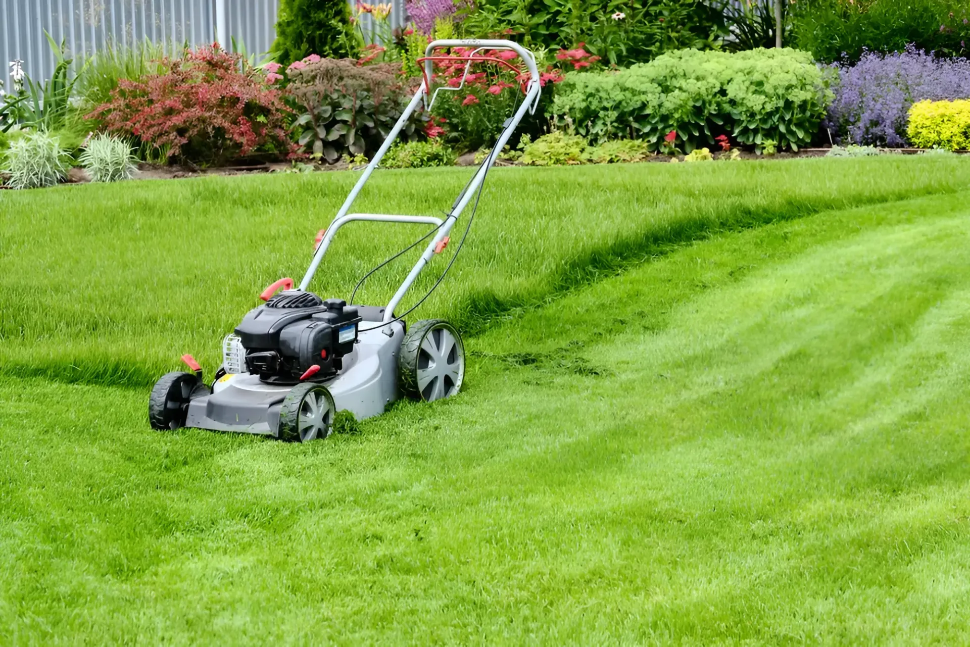 Lawnmower on a Green Lawn With Striped Mowing Pattern — Garden City Slashing in Toowoomba, QLD