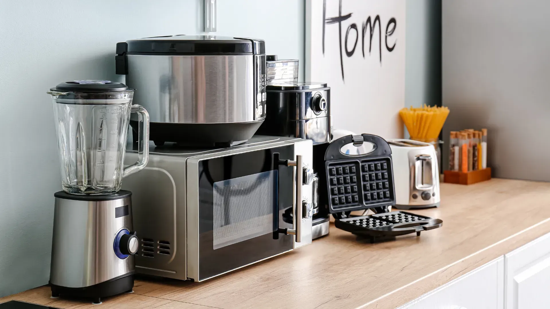 A bunch of kitchen appliances are sitting on a counter.