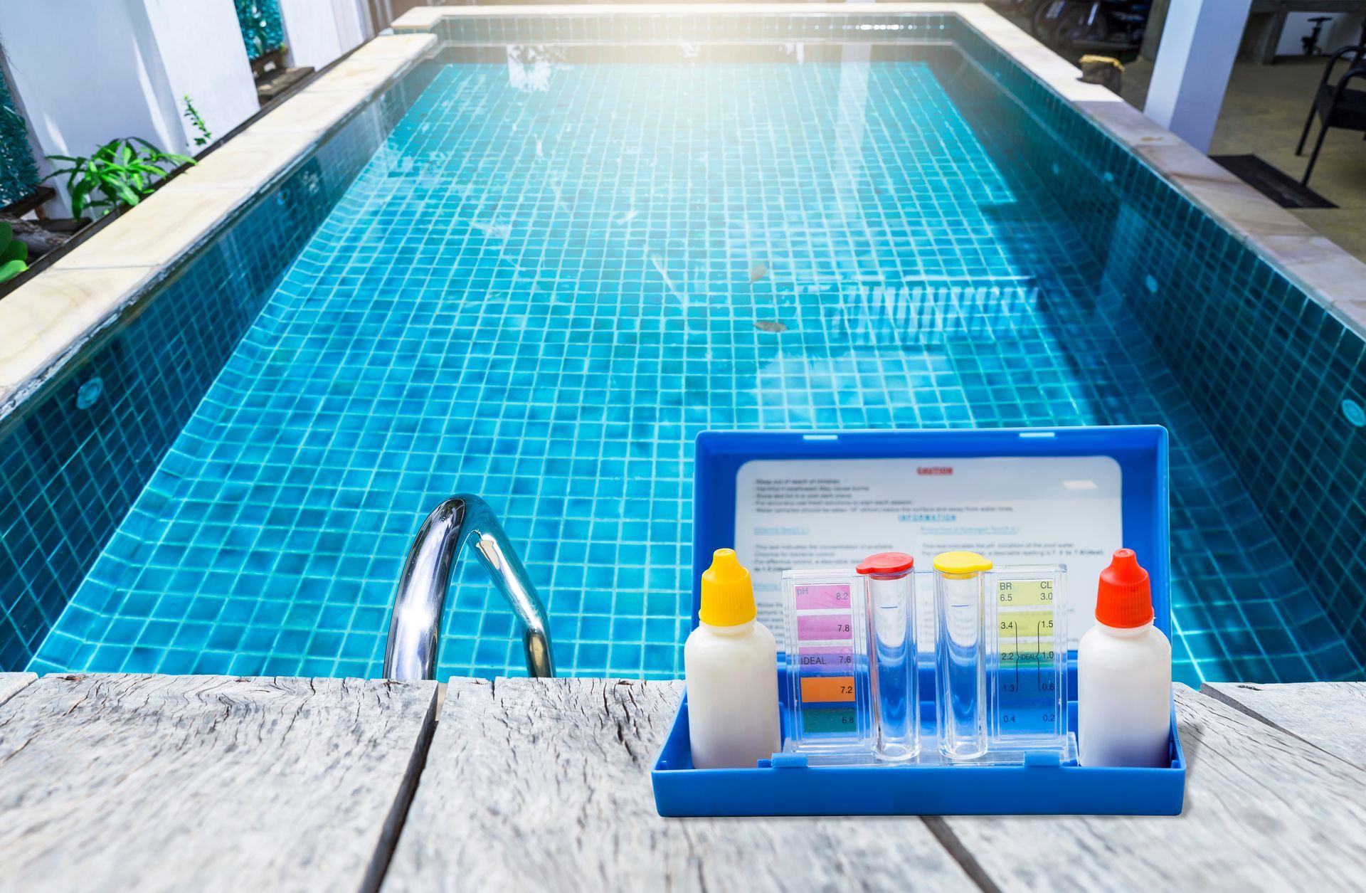 A swimming pool with a box of chemicals next to it.