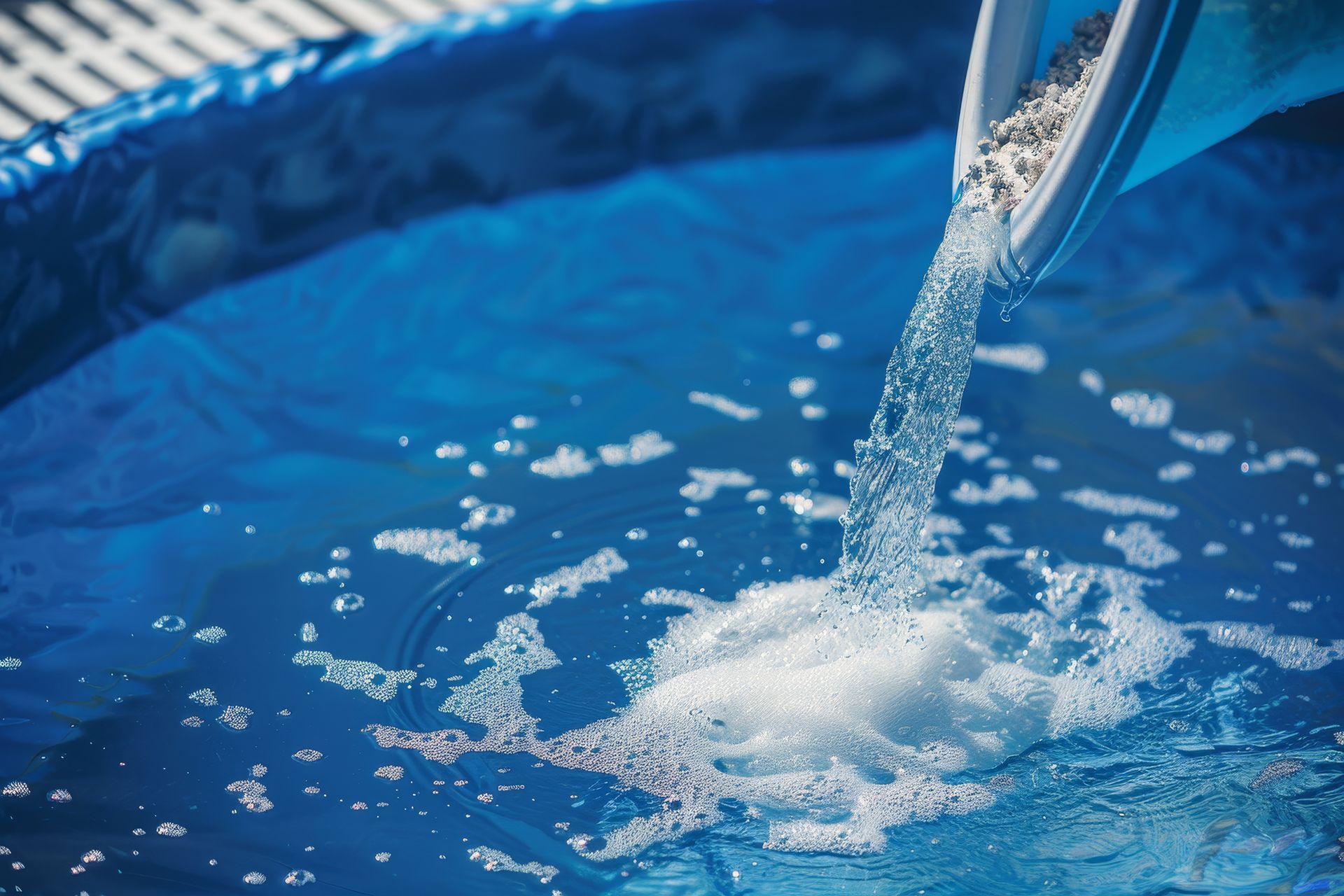 A person is pouring water into a swimming pool.
