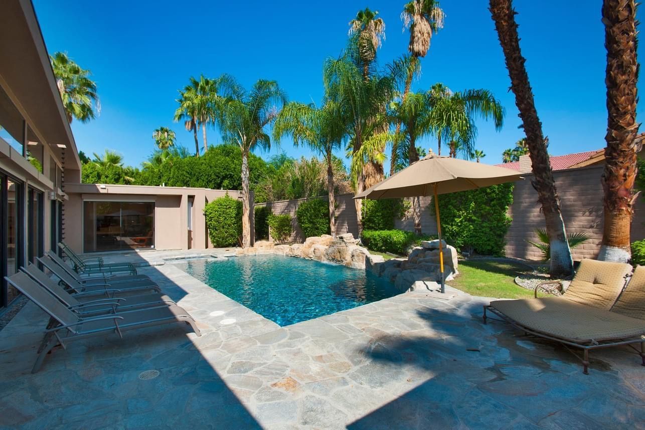 A large swimming pool in the backyard of a house