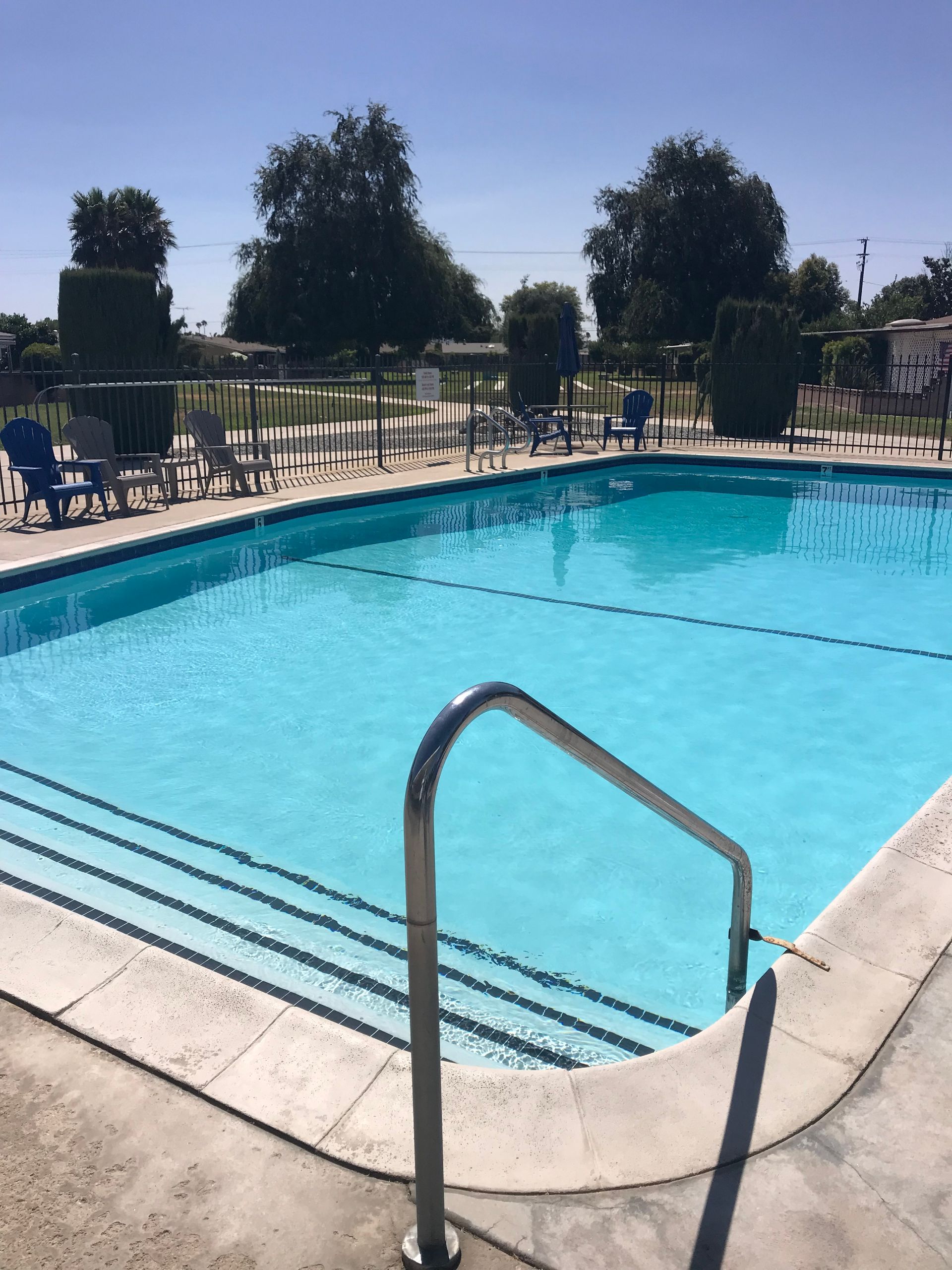 A large swimming pool with stairs leading to it