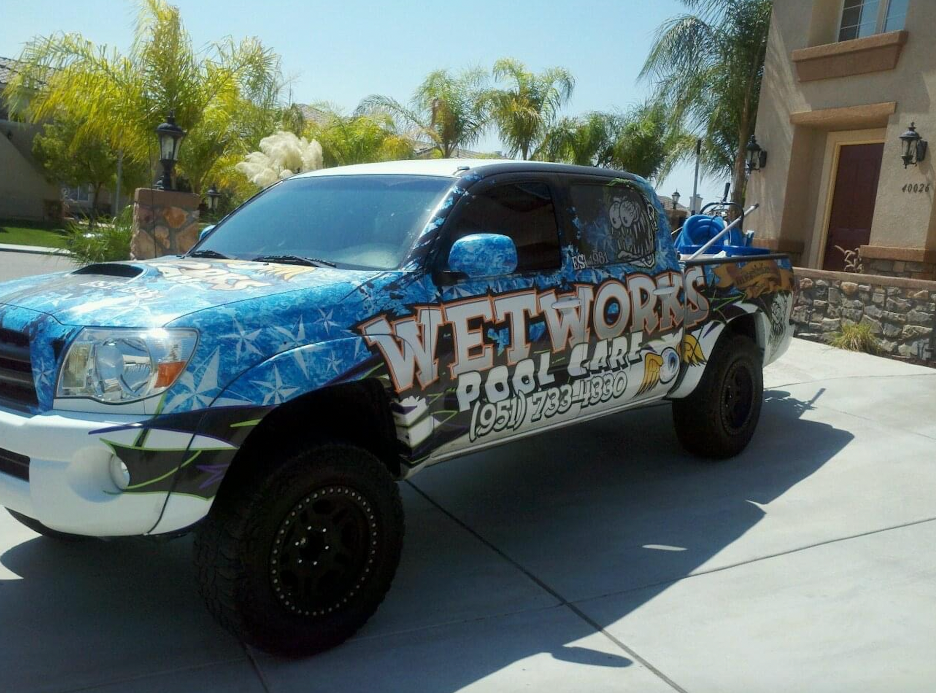 A wetworks truck is parked in front of a house
