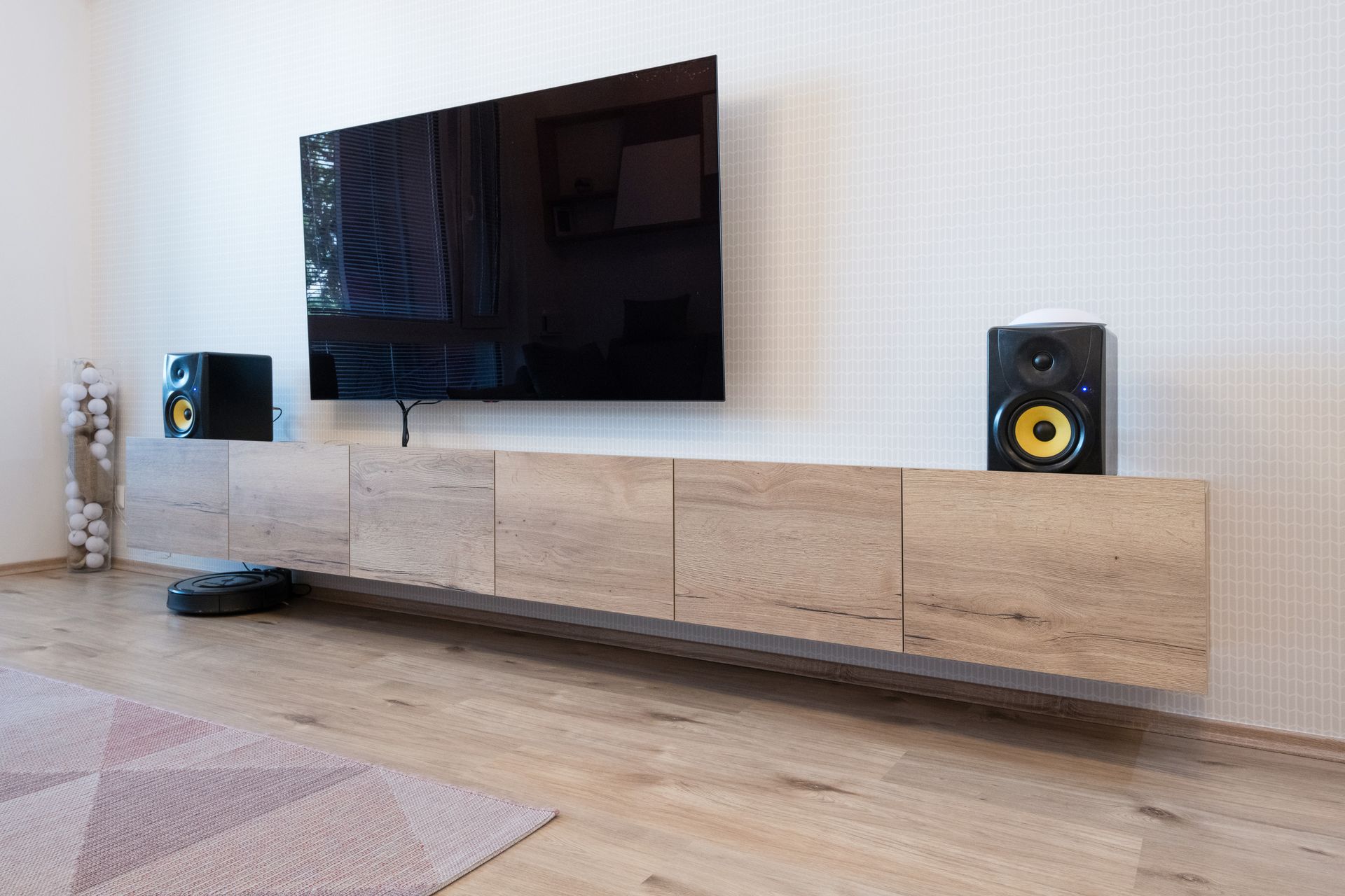 Cabinet and TV with speakers in living room