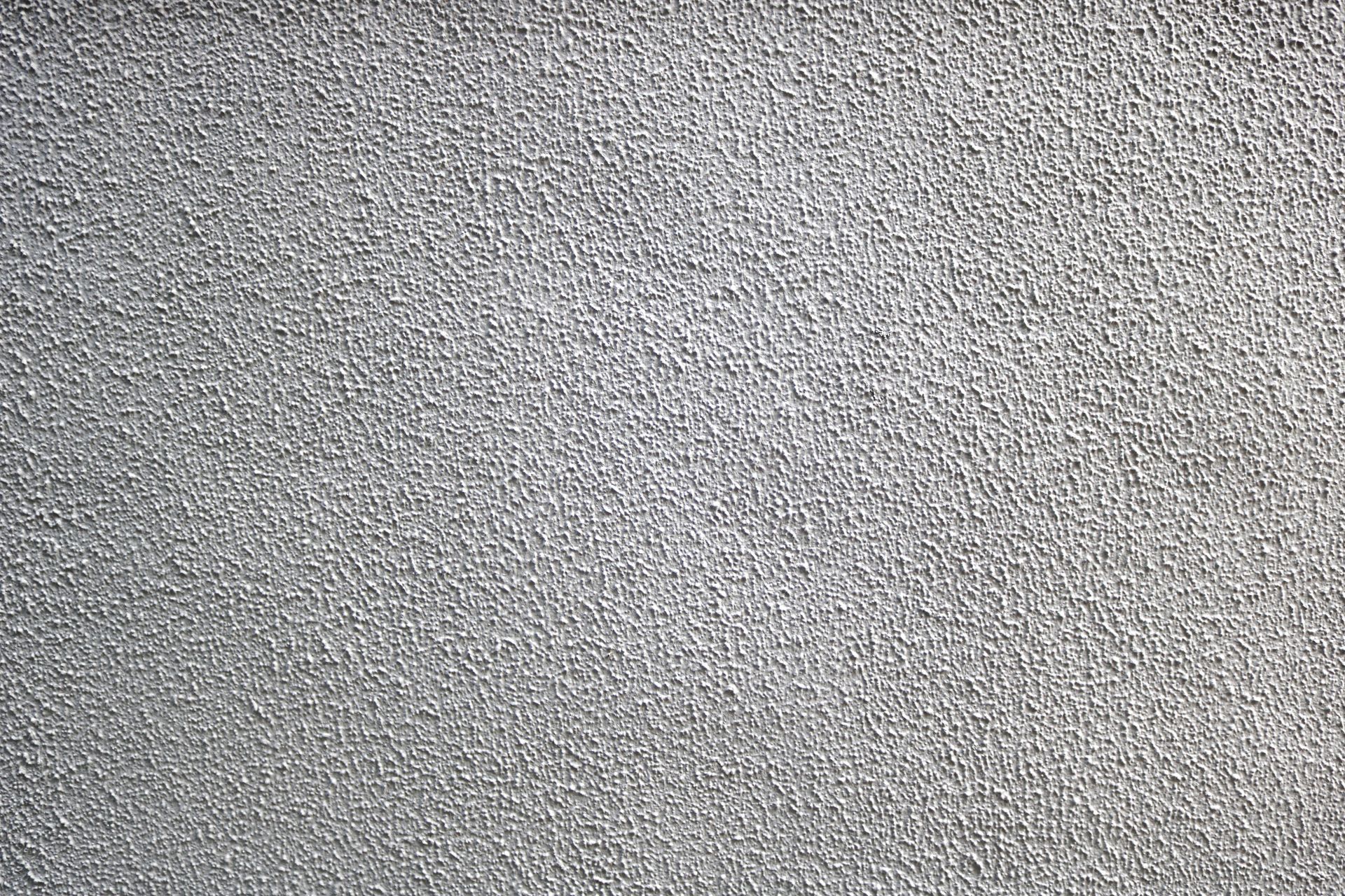 Little popcorn ceiling texture of a blank wall in white color