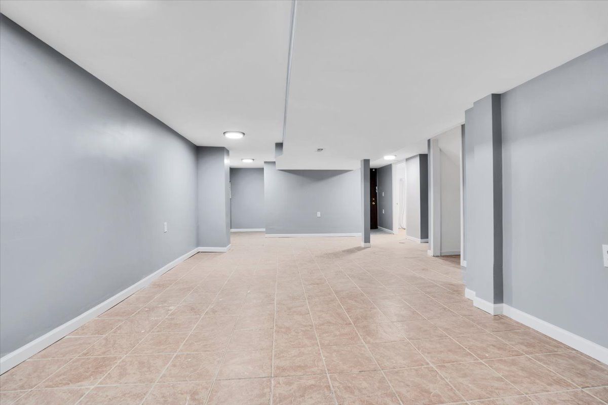 Empty room with gray walls, tile floor, and white ceiling.