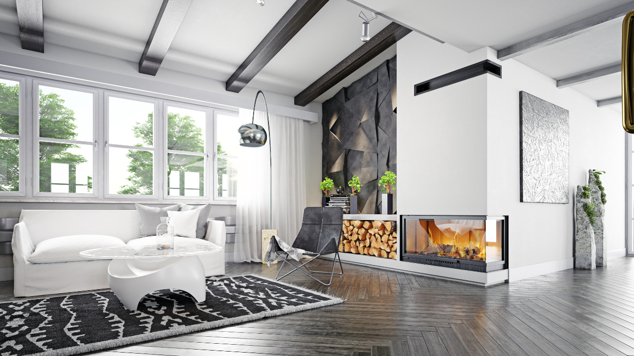 Bright, modern living room with white walls, large windows, fireplace, and dark wood beams.