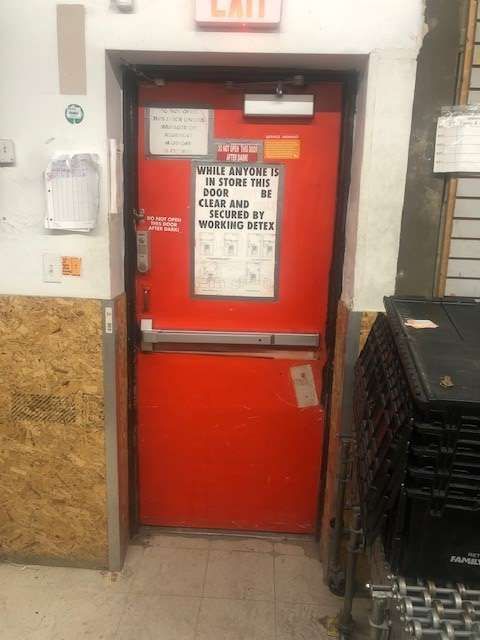 A red door with a sign on it that says exit