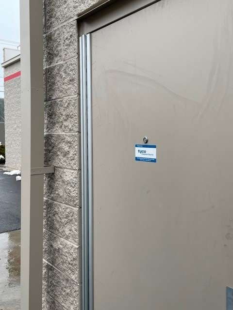 A close up of a door with a name tag on it.