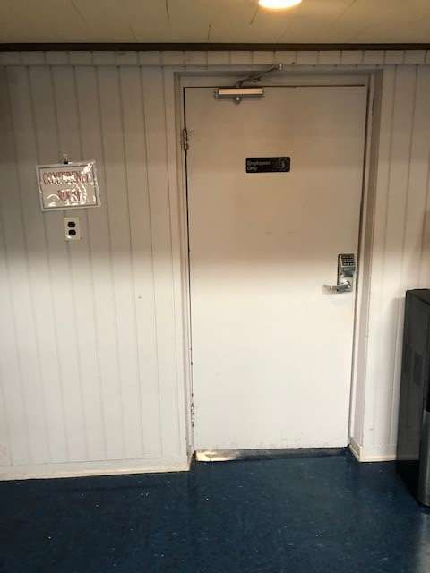 A white door in a room with a blue floor