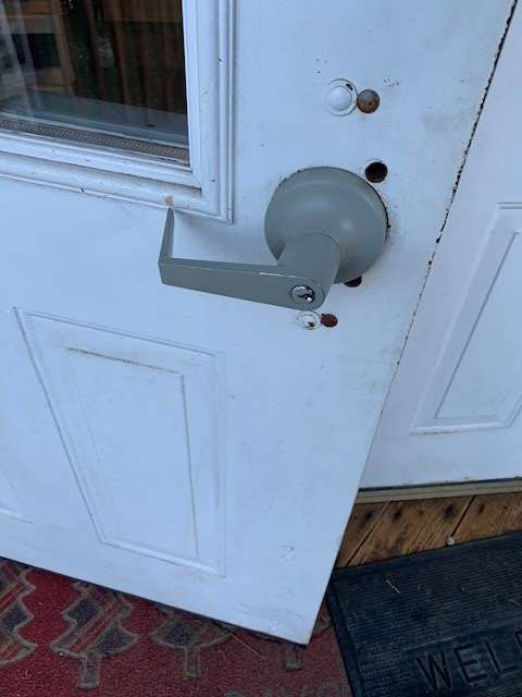 A close up of a door with a handle on it.