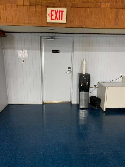 There is a red exit sign above the door.