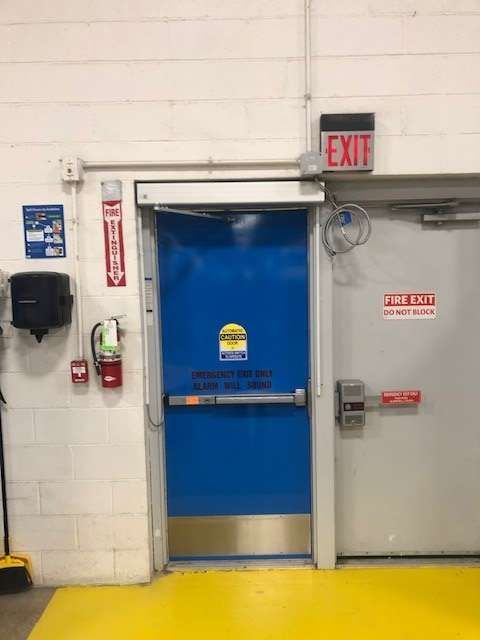 A blue door with an exit sign above it
