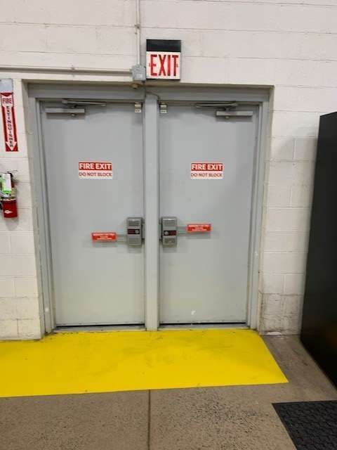 A pair of doors with an exit sign above them