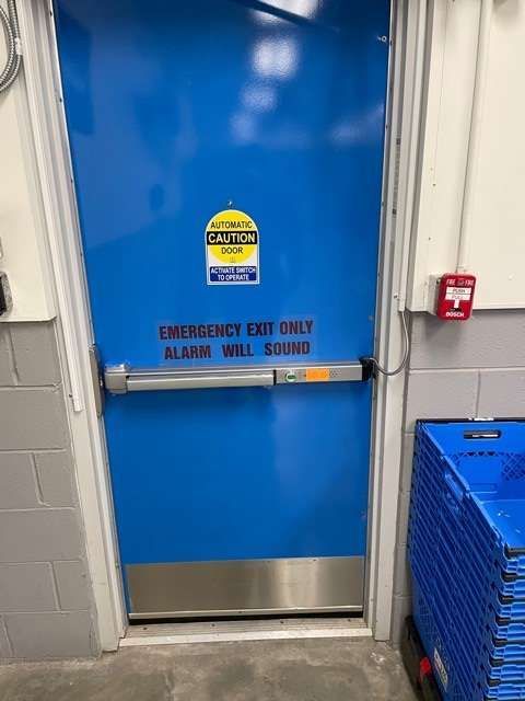 A blue door with a sticker on it that says 