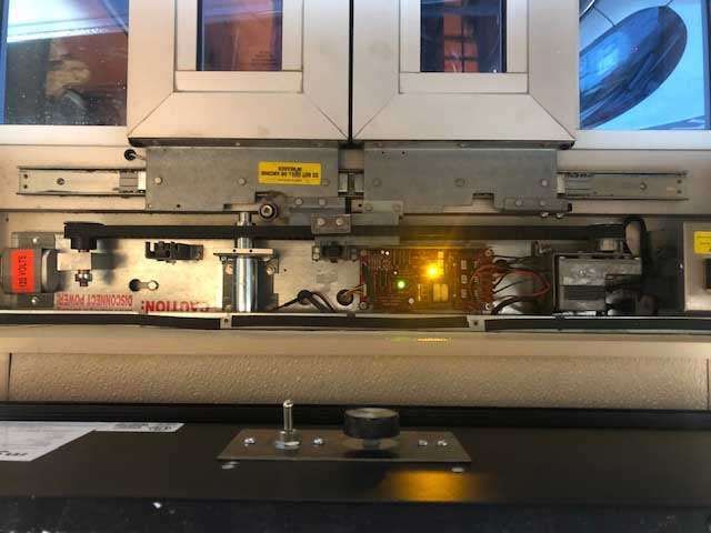 A sliding glass door with a yellow light on it