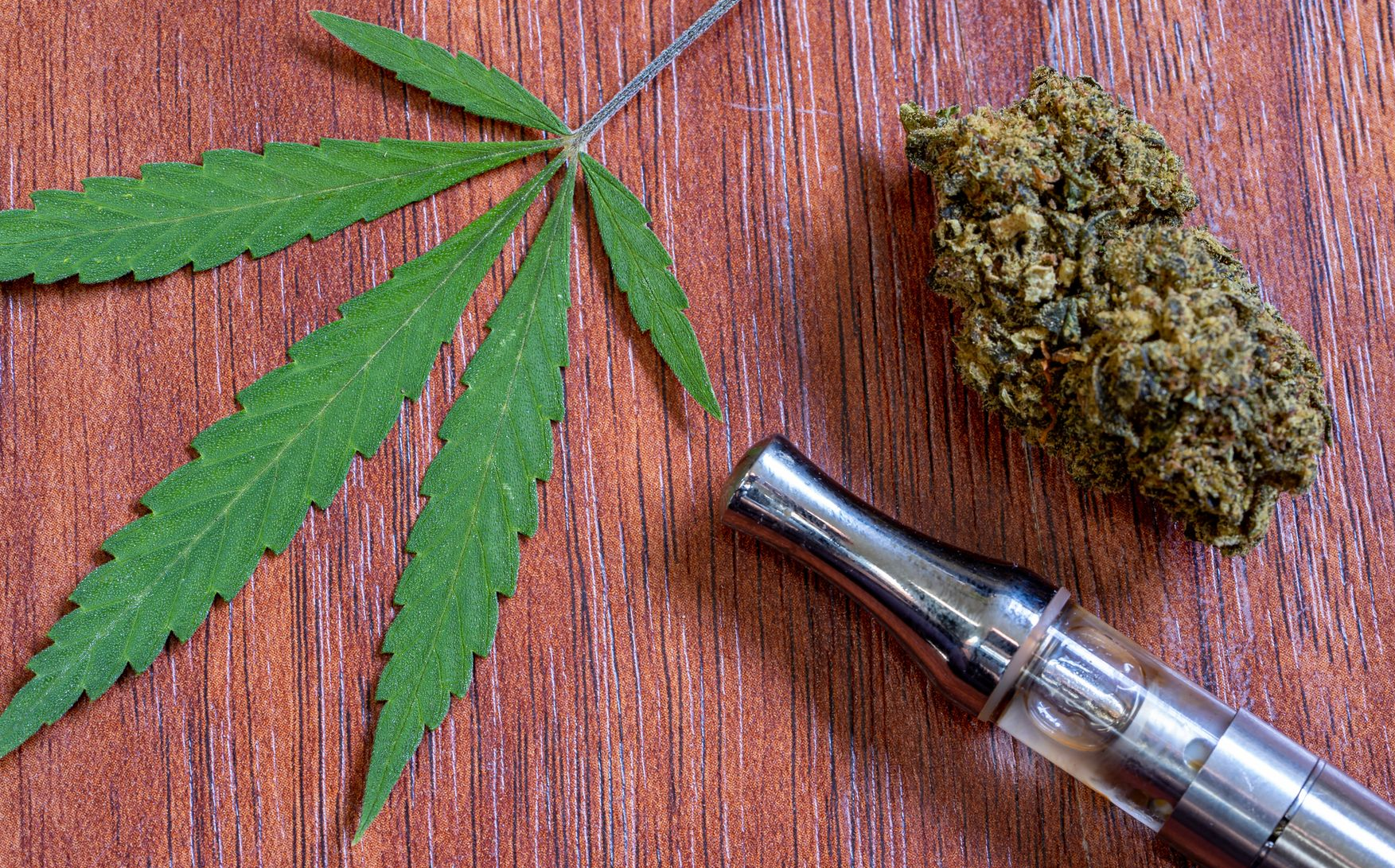 CBD vaporizer with a cannabis leaf and weed stock photo