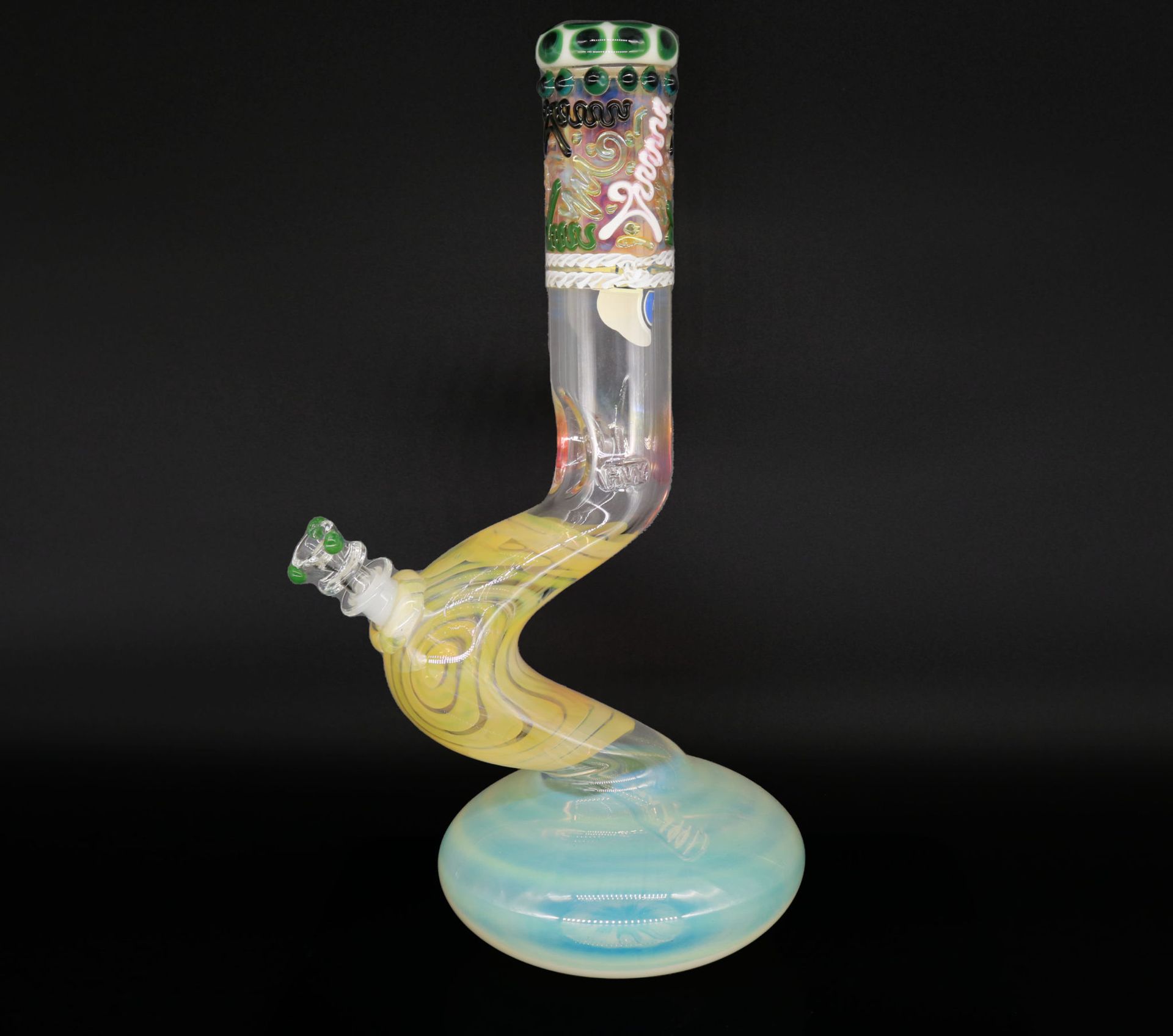 A glass pipe with a swirl on it is sitting on a table.