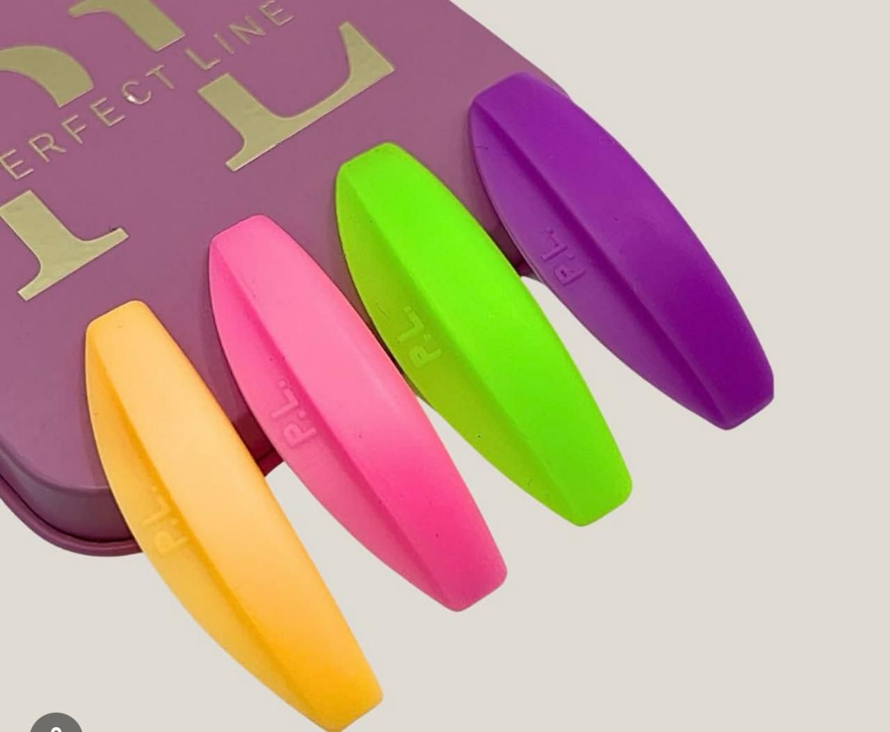 a purple box with a bunch of colorful nail clips on it