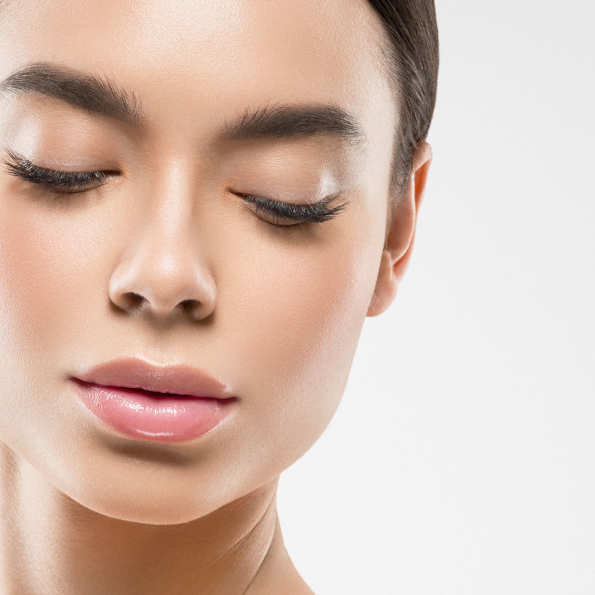 a close up of a woman 's face with her eyes closed .